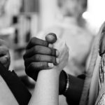 black and white hands holding together