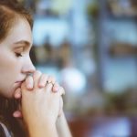 A woman prays.
